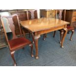 A walnut extending dining table on Queen Ann style legs and four matching chairs. IMPORTANT: