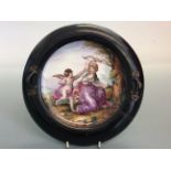 A Carl Thieme Dresden plate mounted in ebonised frame depicting cupid and psyche, 26cm. IMPORTANT: