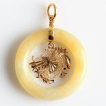A jade circle design pendant, with a central open metalwork dragon dropper, unmarked yellow metal,