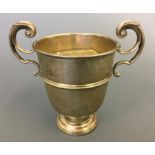 A small silver two handled trophy, hallmarked London 1922, height approx. 10cm, total weight approx.