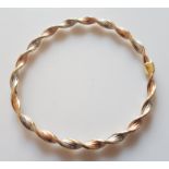 *A hallmarked 9ct tri-gold twist design bangle. IMPORTANT: Online viewing and bidding only. No in