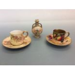 Three pieces of Royal Worcester to include two cups and saucer and one small vase. IMPORTANT: Online