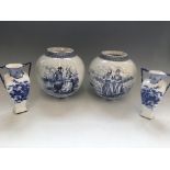 Four vases, two include two Royal Bonn Delft squat vases, heights 22cm, with a pair of blue and