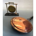 A table topped brass gong together with a copper bed warming pan. IMPORTANT: Online viewing and