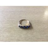 A yellow metal presumed gold ring, of five graduated sapphires, ring size T. approx. weight 2.58gms.