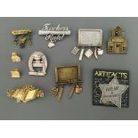 Eight Jonette Jewelry pin brooches, some with hanging charms, with two pin badges, including ‘