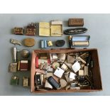 A box of various items including lighters, a pocket watch, a leather cased portable miniature sewing