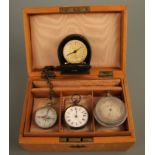 A box containing pocket travel clock in box, white dial pocket watch, two compasses. IMPORTANT: