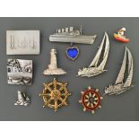 Ten Jonette Jewelry Company nautical pin brooches, including boats, lighthouses and steering wheels.