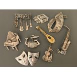 Nine Jonette Jewelry Company music and theatre pin brooches, including piano, cello, drums, guitar