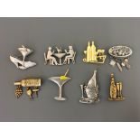 Eight Jonette Jewellery pin brooches, some with hanging charms, including ‘pasta lover’, wine with