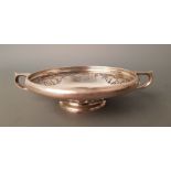 A silver two handled dish with grapes and fruit foliage. IMPORTANT: Online viewing and bidding only.