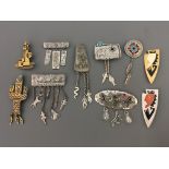 Ten Jonette Jewelry Company pin brooches, some with hanging charms, including cactus, dancing figure