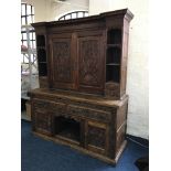 An oak early 19th century cupboard top dresser fitted with two drawers to base and later carving