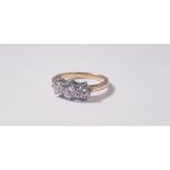 A three stone diamond ring, set with three graduated round brilliant cut diamonds, the principal