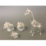 A boxed Swarovski giraffe, together with three elephants, two boxed. IMPORTANT: Online viewing and