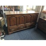 An early 19th century oak four panel two drawer mule chest. IMPORTANT: Online viewing and bidding