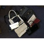 Approximately eighteen various handbags and purses including black, navy, brown, red, gold, etc.