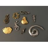 Eight Jonette Jewelry pin brooches and one pin badge depicting snakes, lizards and dragon.