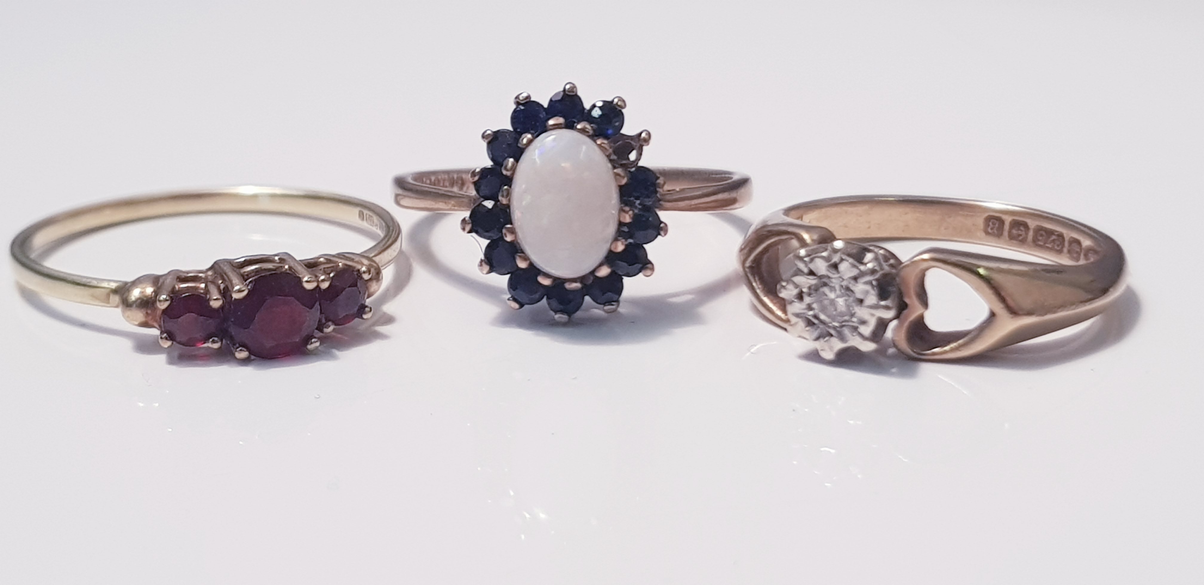 A 9ct yellow gold opal and sapphire cluster ring, (one sapphire missing), ring size L 1/2, approx.