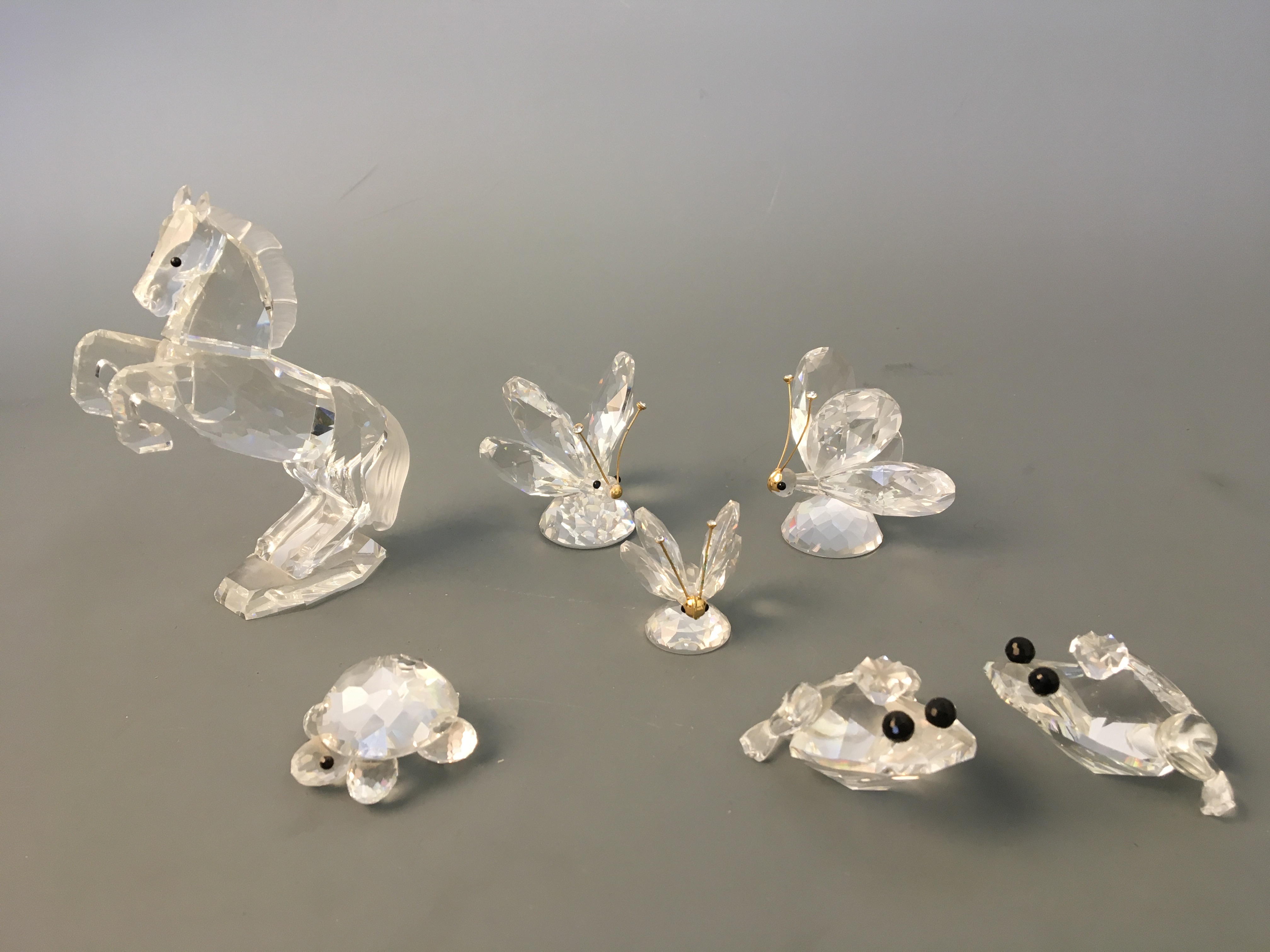 Three Swarovski butterflies, two frog prince, turtle and rearing horse, four boxed. IMPORTANT: