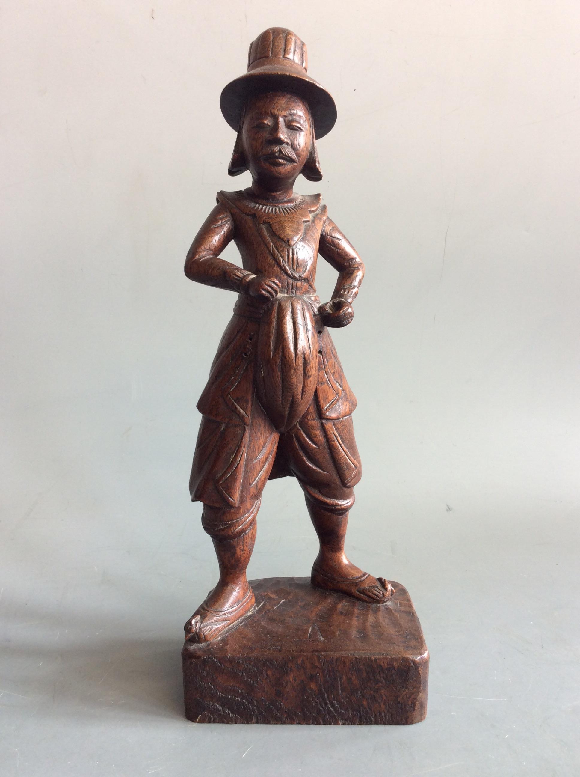 A wooden carved figurine wearing 17th century dress, height 32cm. IMPORTANT: Online viewing and