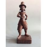 A wooden carved figurine wearing 17th century dress, height 32cm. IMPORTANT: Online viewing and