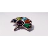 A multi coloured gem stone brooch of fan design. IMPORTANT: Online viewing and bidding only. No in