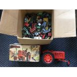 A boxed Nuffield Universal model tractor with a box containing various Matchbox model vehicles.
