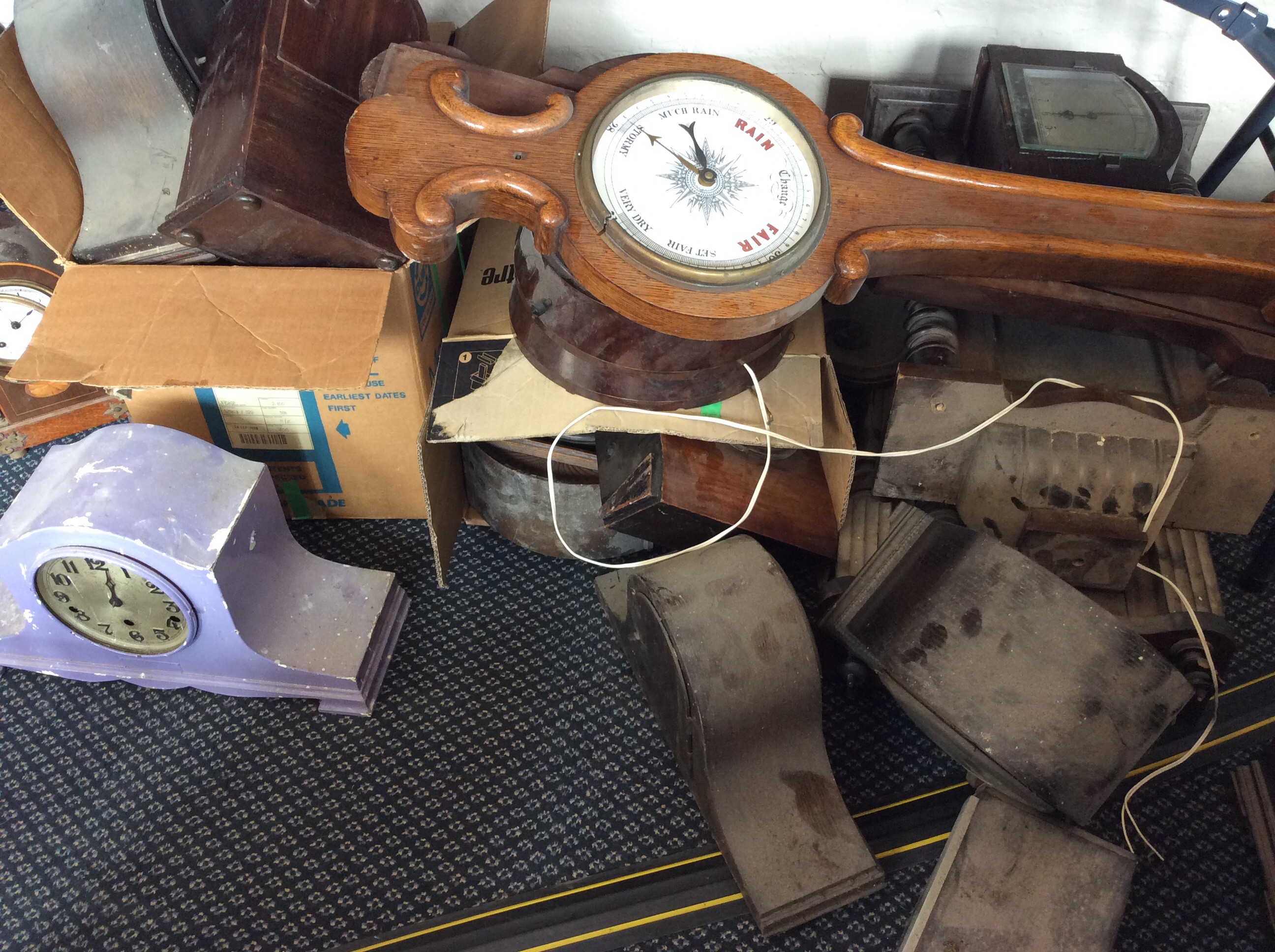 A selection of various clocks, clock faces and barometers, including mantel clocks, wall hanging