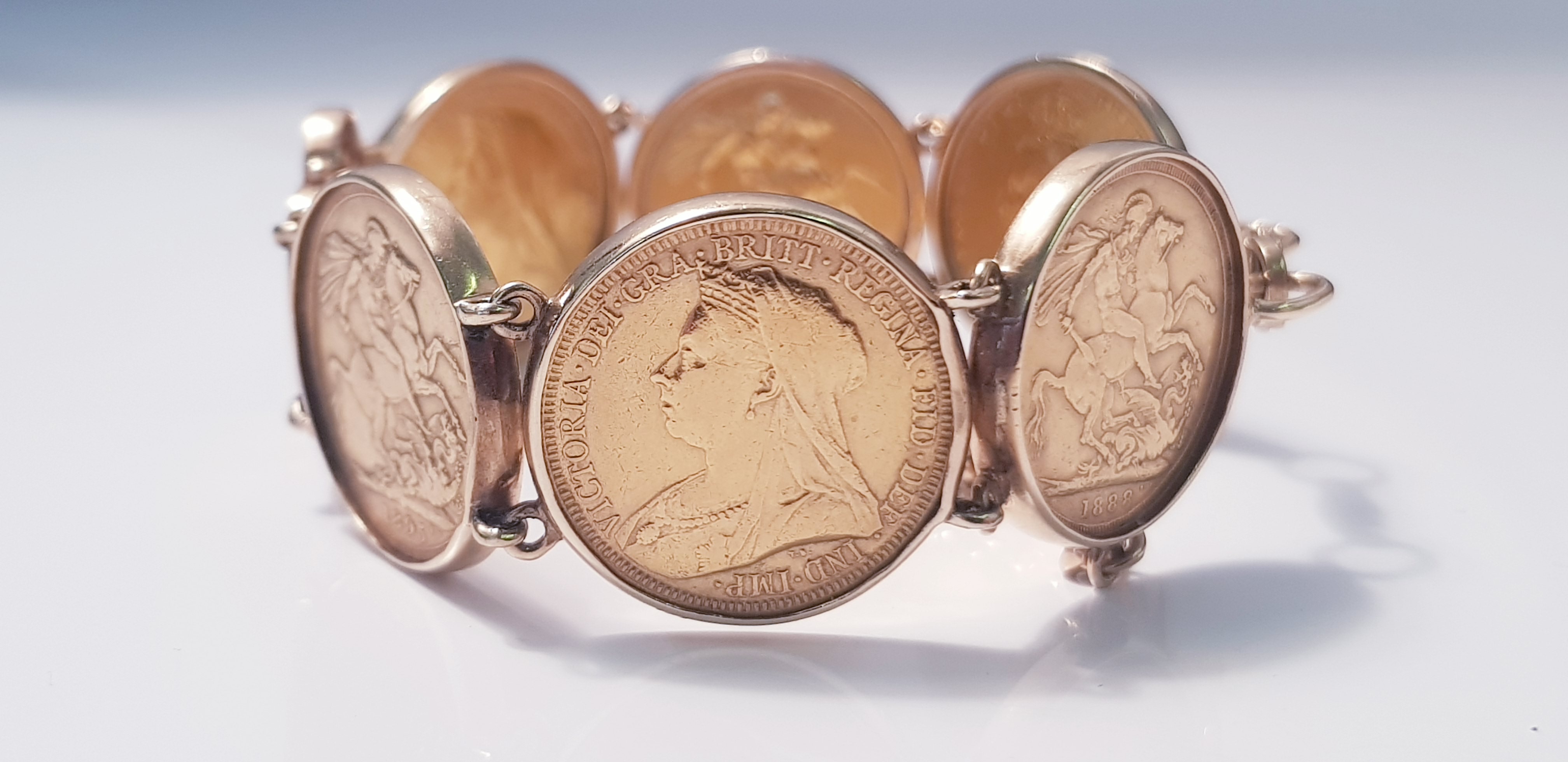 A bracelet of 6 gold Sovereigns, dated 1888,1896,1895,1900,1888,1889 with safety chain, approx.