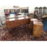 A teak five drawer dressing table with mirror back and a pair of walnut single door pot cupboards.