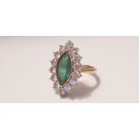 A yellow gold marked 750, Marquise emerald and diamond cluster ring, 14 diamonds surrounding
