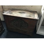 A 19th century oak blanket box with single drawer to base with later carving of family crest shield.