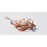A Mikimoto pearl brooch, set with seven variously sized pearls, smallest measuring approx. 6mm and