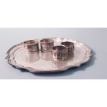 A plated ware tray, approx, width 10" with four various napkin rings, two hallmarked. IMPORTANT: