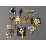 Eleven Jonette Jewelry pin brooches including sun, star, jewels and Egyptians designs, some with .