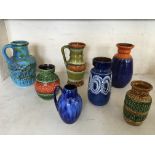 Seven West German pottery jugs and vases in blue, orange and green. IMPORTANT: Online viewing and