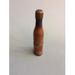 A turned fruitwood portable pipe in the for. Of a bottle, inscribed to copper cap ‘William Taylor