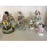 Pair of figurine candlestick holders, together with couple and lambs figurine group (all chipped and