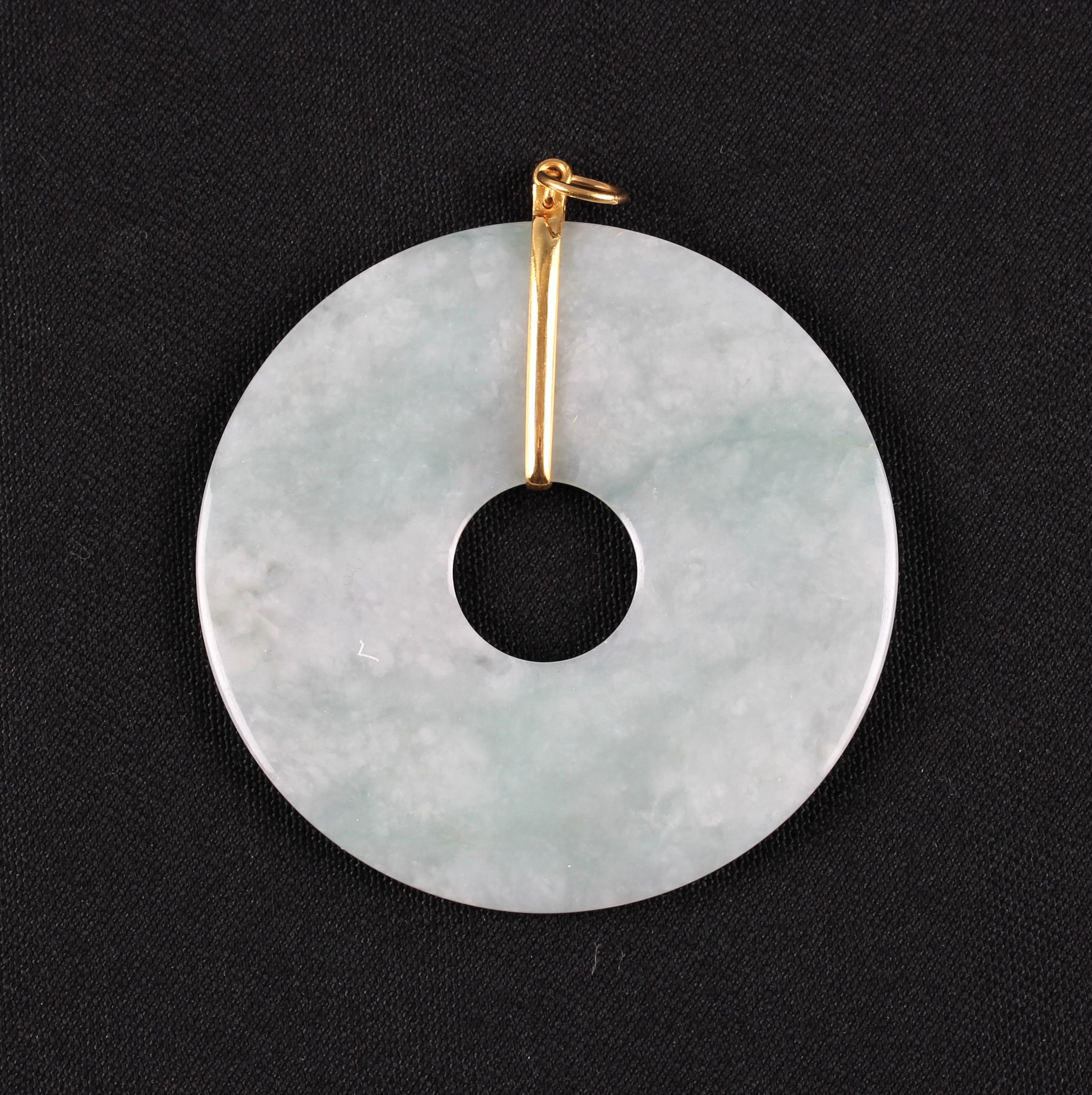 A green jadeite jade pi disc pendant, unmarked yellow metal mount, diameter approx. 5.2cm.