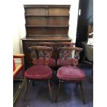 A dark stained elm Ercol dining room group comprising a kitchen dresser, drop leaf table and four