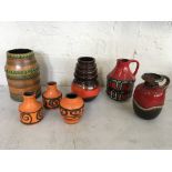 Seven West German pottery vases and jugs in red, orange and brown. IMPORTANT: Online viewing and