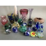 A collection of glass paperweights and studio glass vases, including Strathearn blue flower egg