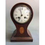 A mahogany balloon cased mantel clock with wooden inlay design and border, height 27cm. IMPORTANT: