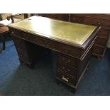 A mahogany reproduction green leather topped desk