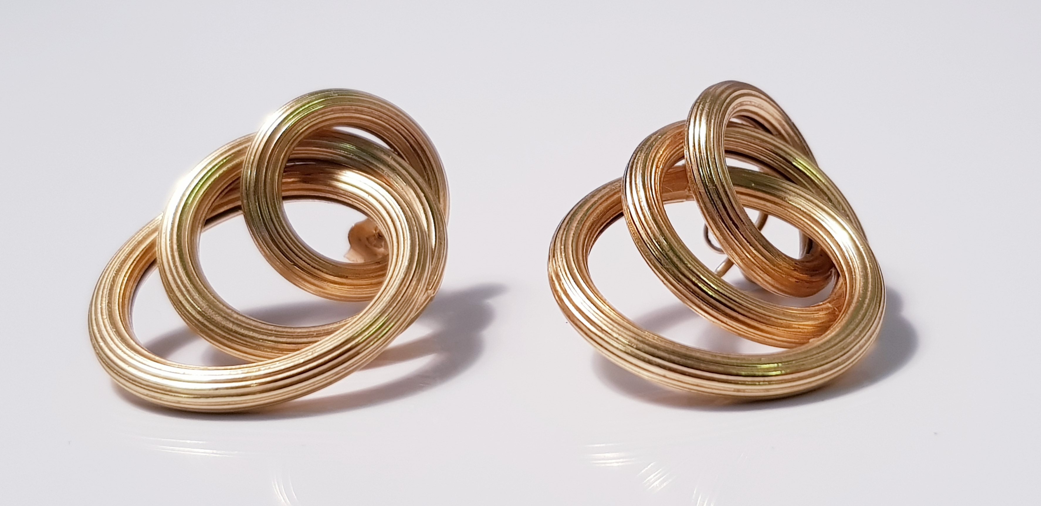 A pair of yellow metal triple hoop earrings, approx. weight 8gms. IMPORTANT: Online viewing and