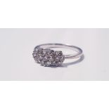 A white gold triple stone diamond ring, each diamond made up of seven tiny diamonds, total approx.