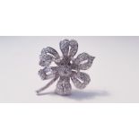 A diamond set flower design brooch, the open metalwork flower set with variously sized round