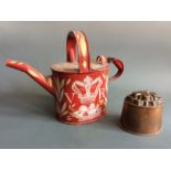 A bargeware red and yellow painted watering can with Queen Victoria insignia and ship design, with